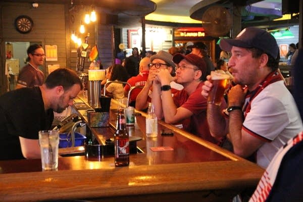 Fans gather at a local bar for a watch party