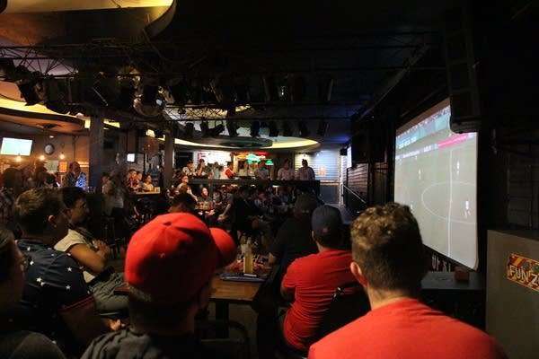 Fans gather at a local bar for a watch party
