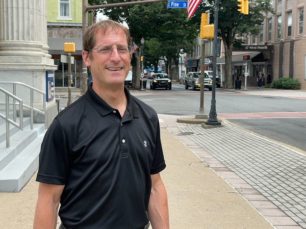 Williamsport Lycoming Chamber of Commerce President and CEO Jason Fink stands on a street in downtown Williamsport, Pa.