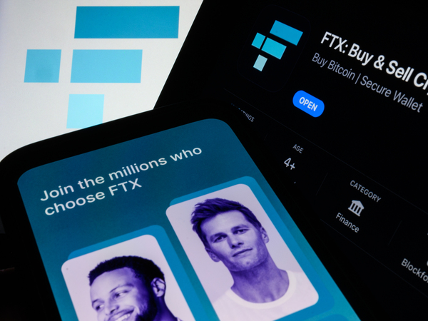 In this photo illustration the FTX logo and mobile app adverts are displayed on screens in London on Nov. 10, 2022. FTX hired celebrities to promote the company or lured them as investors. Retired football star Tom Brady and basketball star Stephen Curry reportedly acted as brand ambassadors for FTX.
