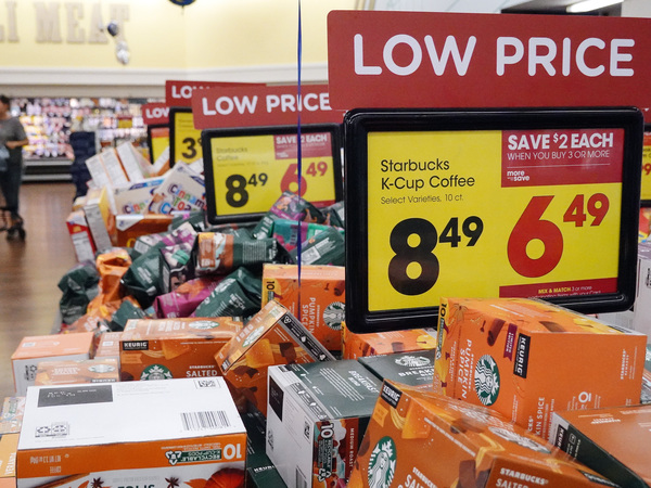 "Low Price" signs are displayed at a grocery store in Los Angeles on Oct. 12. Inflation is gradually moderating, though it continues to impact people across the United States.