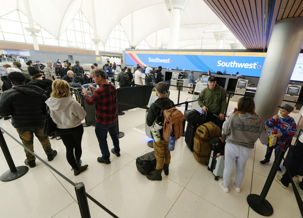Travelers wade through the line for service at the Southwest Airlines check-in counter in Denver International Airport on Dec. 27, 2022. Over a 10-day period last December, the airline cancelled more than 16,000 flights.