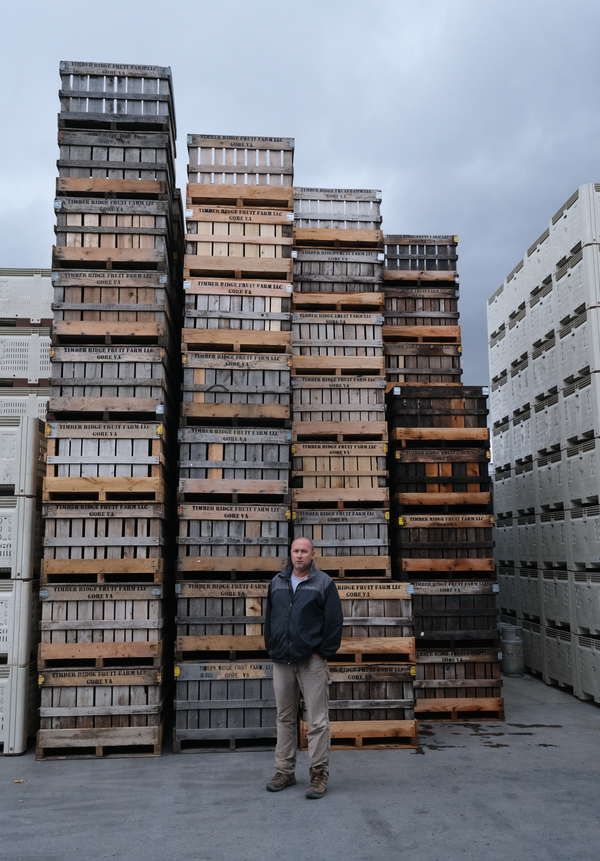Cordell Watt, co-owner of Timber Ridge Fruit Farm in Gore, Va., poses in front of his crates.