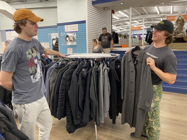 Ben Foster of Chattanooga, Tenn., (left) decides what he thinks about the tweed coat his friend Josh Elliott of Atlanta shows him. Elliott had heard about the Unclaimed Baggage store from a friend and was amazed by how organized it is.