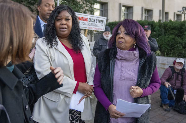 Wandrea "Shaye" Moss, second from left, and her mother Ruby Freeman, right, leave after speaking with reporters outside federal court, Friday, Dec. 15, 2023, in Washington. A jury awarded $148 million in damages on Friday to the two former Georgia election workers who sued Rudy Giuliani for defamation over lies he said about them in 2020 that upended their lives with racist threats and harassment.