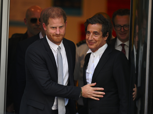 Prince Harry leaves court with his lawyer David Sherborne in June after testifying against Mirror Group Newspapers. The court agreed on Friday that the tabloid chain had unlawfully hacked into Harry's phone to learn private details.