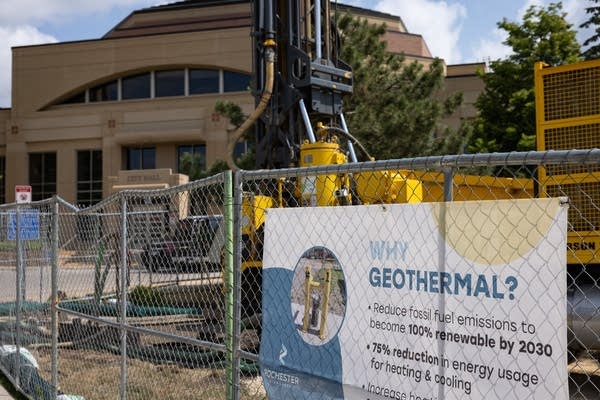 A chainlink fence surrounds a drilling site