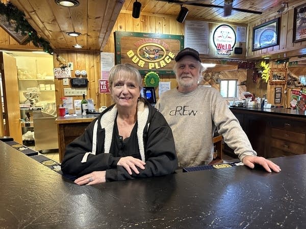 Two people smile at table