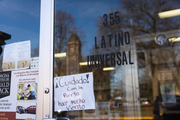 A warning sign on a grocery store door