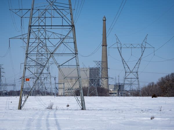 Electrical lines and towers frame a power plant