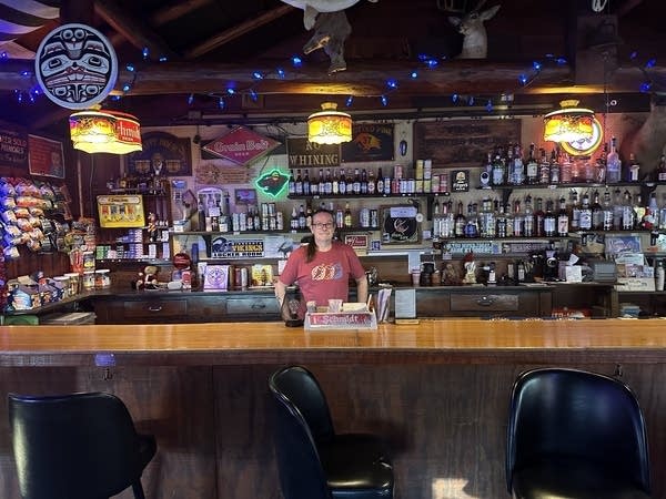 Person stands behind bar