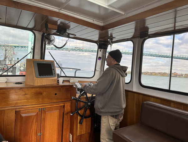 Sam Buchanan pilots a J.W. Westcott mail boat in the Detroit River to rendezvous with another ship, the Great Republic.