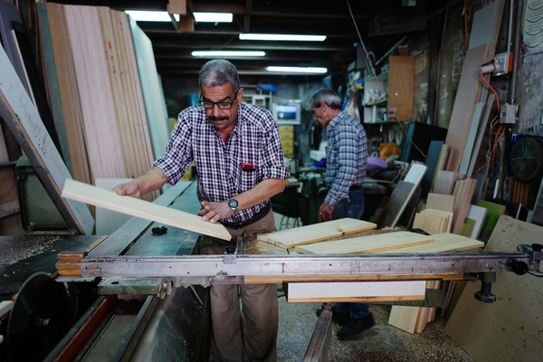 Joudeh Said runs a carpentry business in the West Bank. "No one is paying," he says. "They give me a check, and then the check bounces, and then I have to chase them."