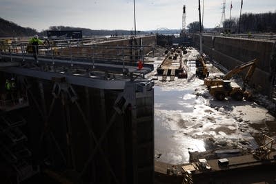 Construction workers repair a miter gate