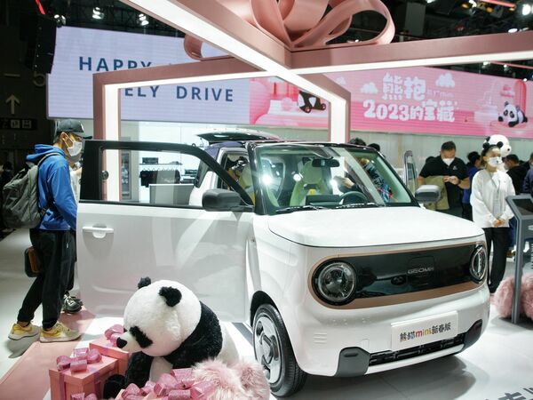 Visitors look at a Geely Panda Mini on the opening day of the 20th Guangzhou International Automobile Exhibition in Guangzhou, in China's southern Guangdong province on Dec. 30, 2022.