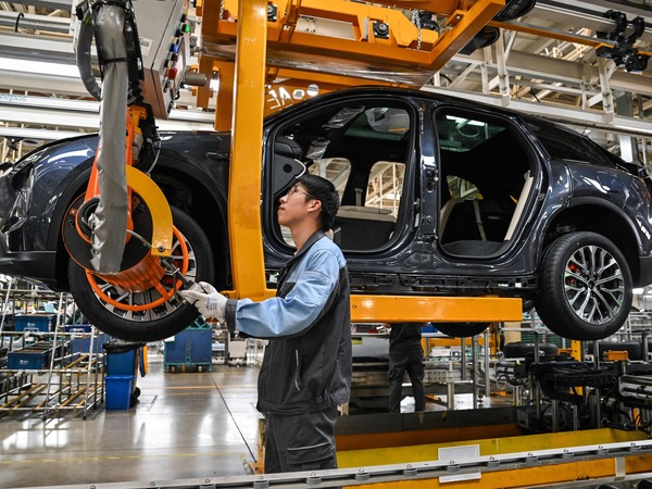 An employee works on a car along the assembly line at a factory of Chinese automaker NIO in Hefei, in China's eastern Anhui province on May 10, 2023. Like other Chinese automakers, Nio has big global ambitions.
