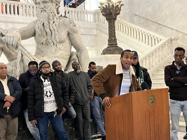 A man talks at a podium