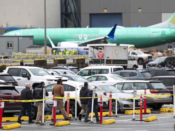Workers and an unpainted Boeing 737 aircraft are pictured as Boeing's 737 factory teams hold the first day of a "Quality Stand Down" for the 737 program at Boeing's factory in Renton, Wash., on Jan. 25.