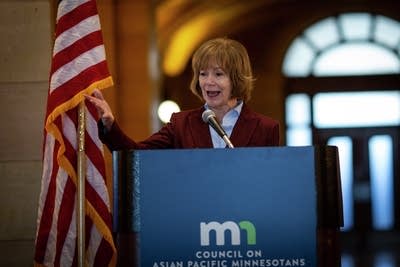 A woman greets a crowd at the capitol 