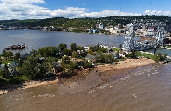 Water surrounds an area of land that is eroded. 