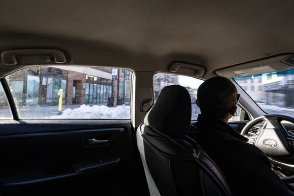 A man's silhouette as he drives a car