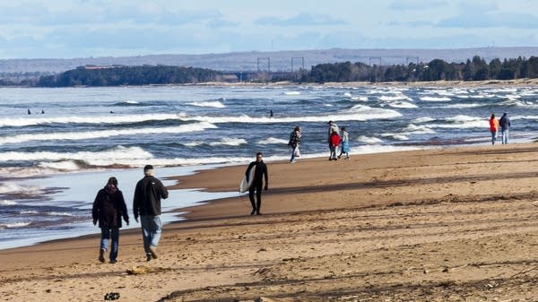 People walk along the beach at Park Point