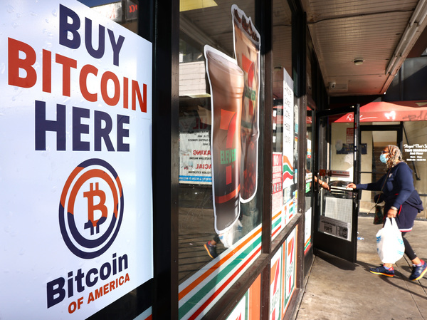A 'Buy Bitcoin Here' sign is posted at a 7-Eleven store in Los Angeles on Nov. 10, 2021. How much the halving contributes to gains in bitcoin has been a subject of continued debate.
