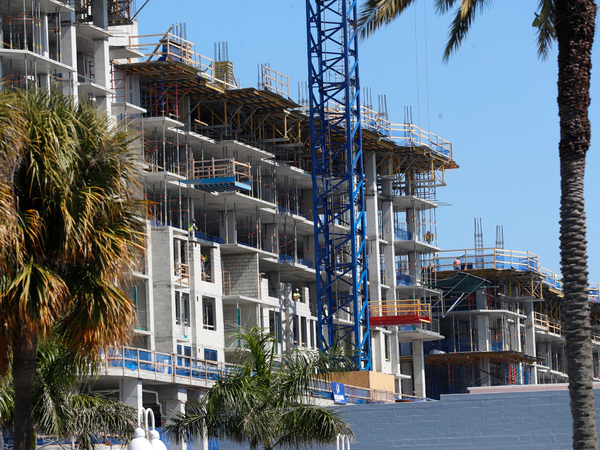 Multifamily buildings can provide single-level living, but some baby boomers are wary of paying condo fees. A mixed-use apartment development is seen under construction in St. Petersburg, Fla., in February.