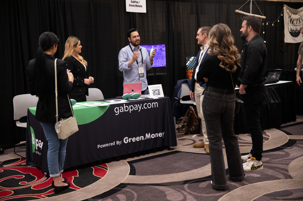 Dan Eddy (center) speaks to attendees at the GabPay booth.