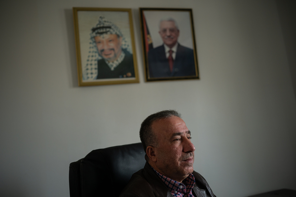 Azmi Abdel Rahman, director of policy with the Palestinian Ministry of Labor, sits for a portrait in his office in Ramallah in the occupied West Bank, on March 24.