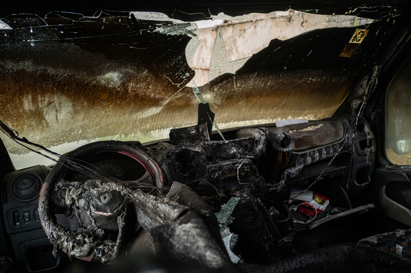 A burned truck that was attacked by Israeli settlers stands beside a road in the Palestinian village of Kafr Ni'ma in the occupied West Bank on March 24.